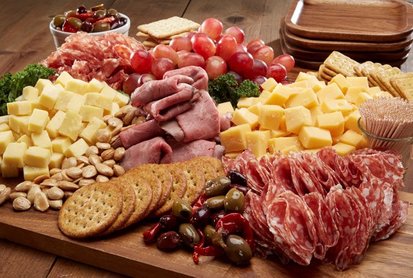 plate of meats cheeses olives and grapes